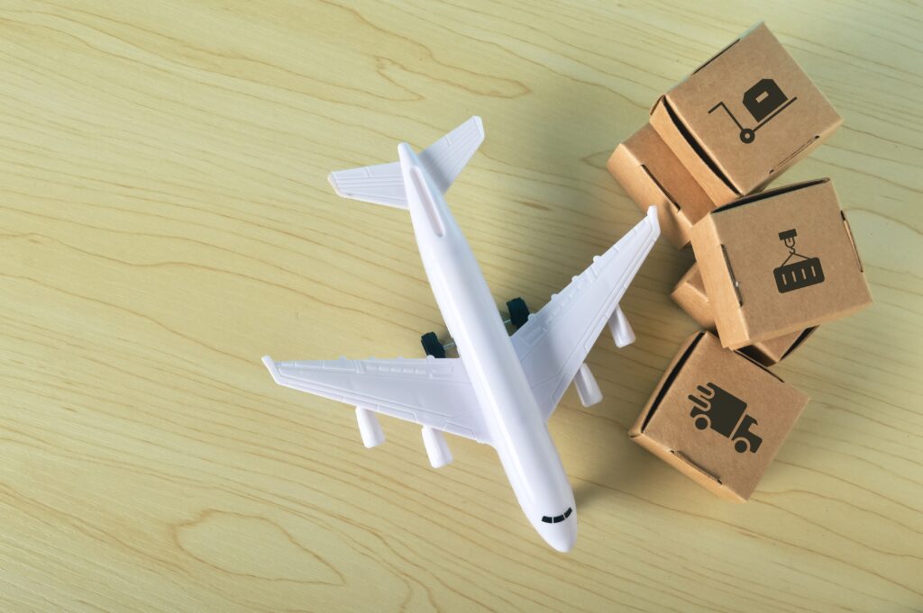 Airplane and shipping boxes representing ecommerce fulfillment, logistics, and 3PL shipping services